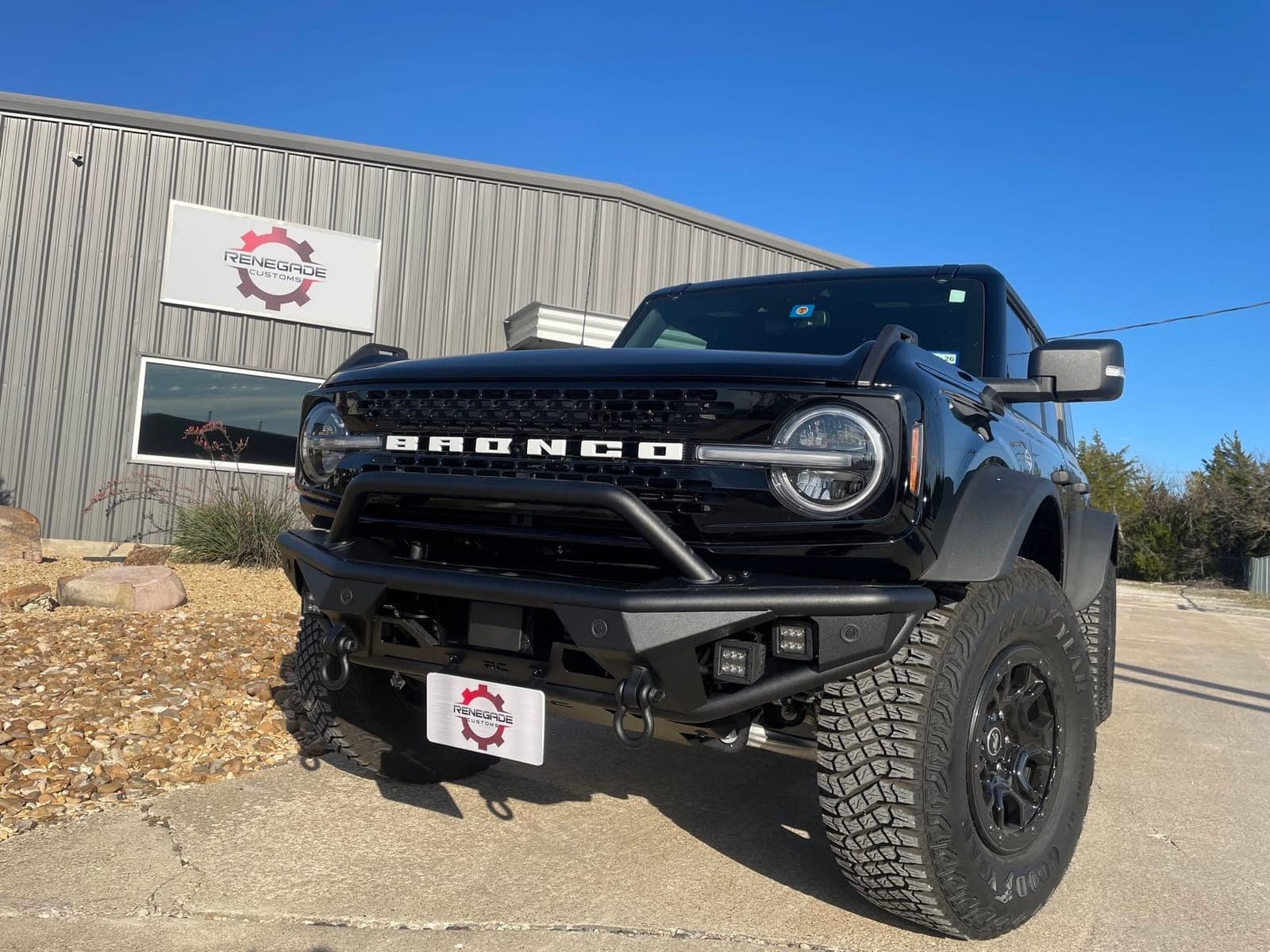Black Ford Bronco with an aftermarket steel front bumper and winch at Renegade Customs