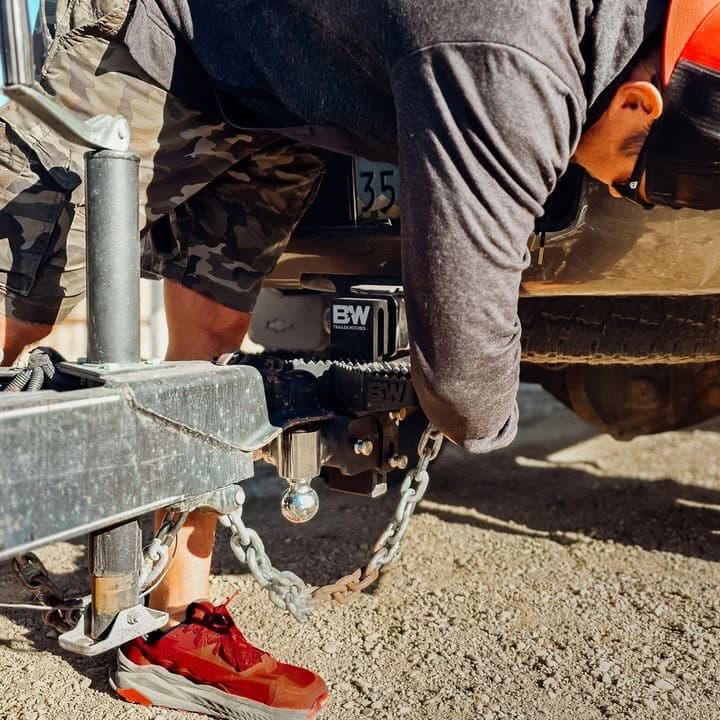 Hooking a trailer coupler to a receiver hitch with safety chains