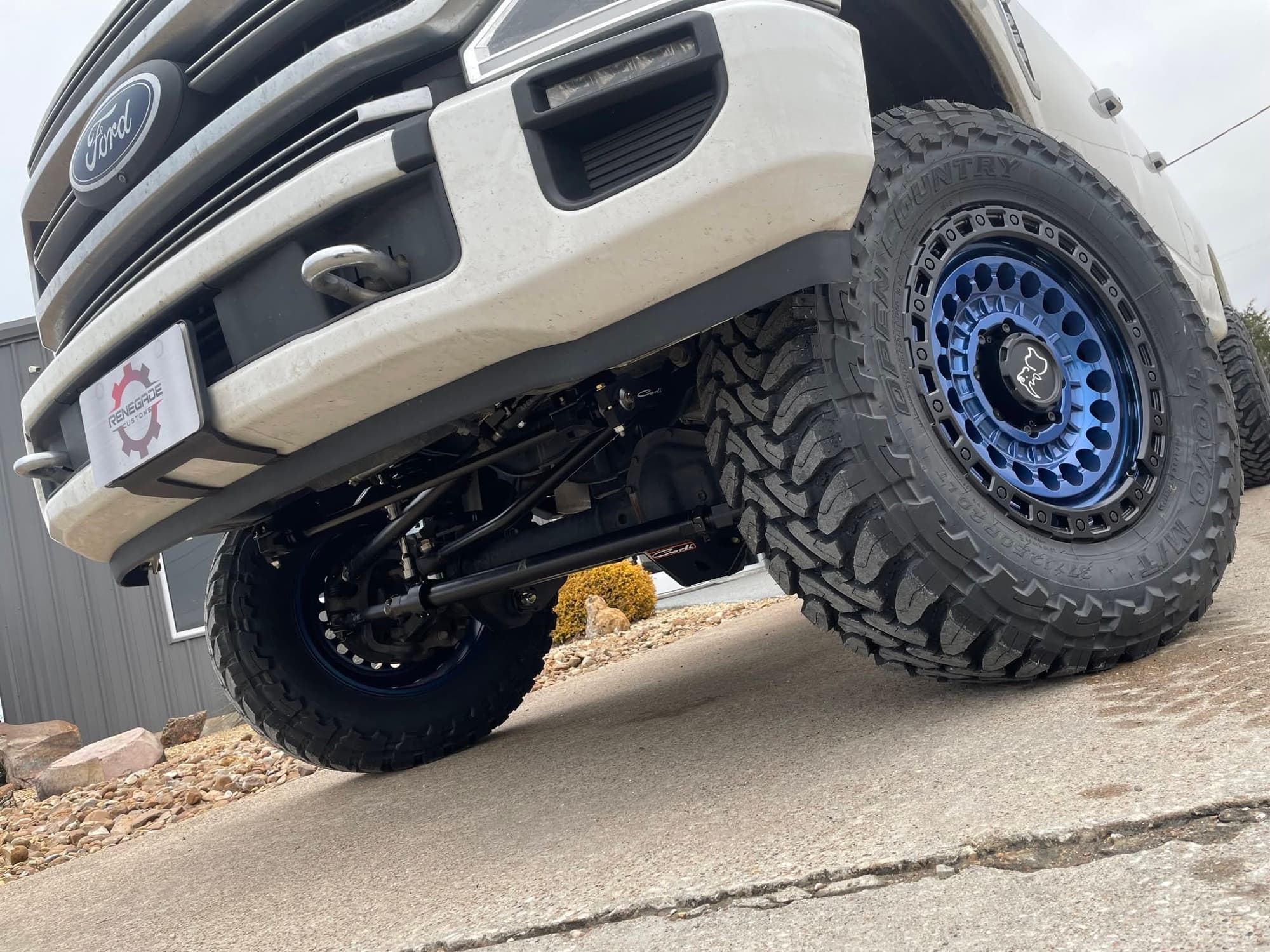 Lifted Ford Super Duty on a lift kit, beadlock wheels and mud tires
